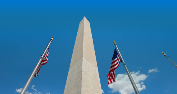 Washington Monument obelisk with US flags on either side